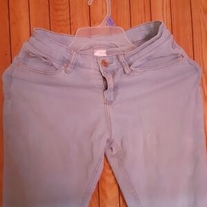 No Boundaries Mid Rise light blue jeans hanging on a hanger